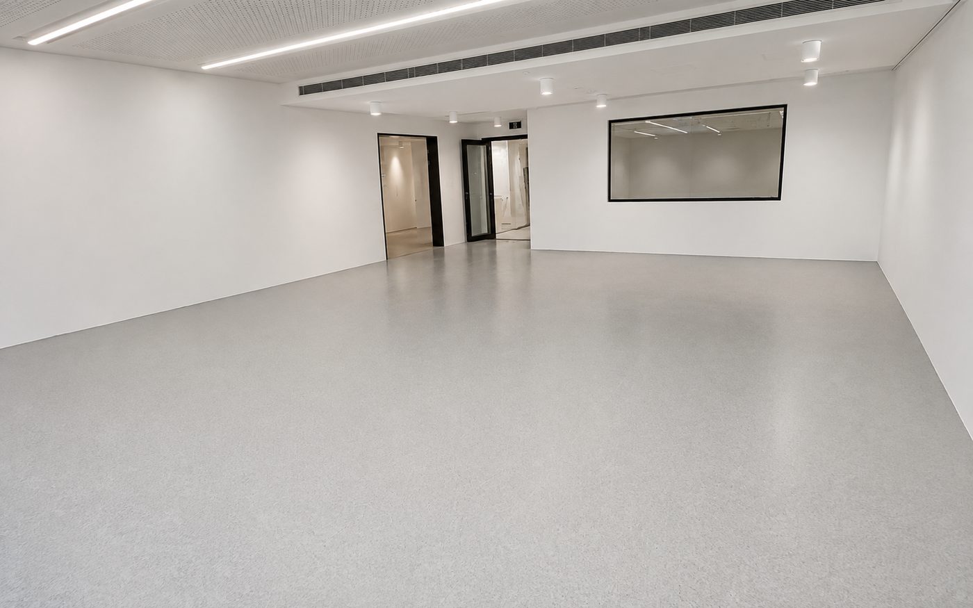 Multipurpose room with a grey vinyl sprung floor and acoustic-panel ceiling